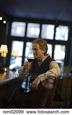 Stock Photograph - man drinking wine 
at bar. fotosearch 
- search stock 
photos, pictures, 
images, and photo 
clipart