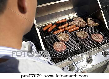 Stock Photograph - man grilling hotdogs 
and hamburgers. 
fotosearch - search 
stock photos, 
pictures, images, 
and photo clipart