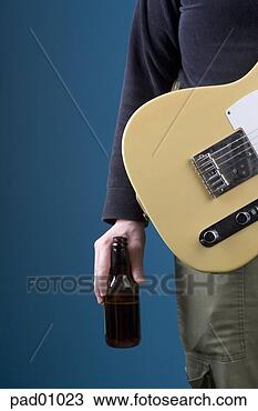 Stock Photo - man holding electric 
guitar and drinking 
beer. fotosearch 
- search stock 
photos, pictures, 
images, and photo 
clipart