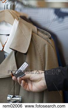 Stock Photo - man holding price 
tag on coat. fotosearch 
- search stock 
photos, pictures, 
images, and photo 
clipart