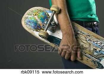 Stock Image - man holding skateboard 
with religious 
sticker. fotosearch 
- search stock 
photos, pictures, 
images, and photo 
clipart