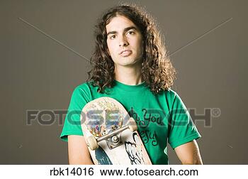 Stock Photo - man holding skateboard 
with religious 
sticker. fotosearch 
- search stock 
photos, pictures, 
images, and photo 
clipart