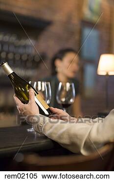 Stock Image - man holding wine 
bottle at bar 
counter. fotosearch 
- search stock 
photos, pictures, 
images, and photo 
clipart