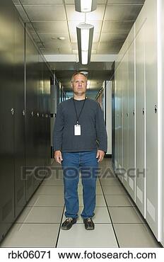 Stock Photography - man with id card 
standing in corridor. 
fotosearch - search 
stock photos, 
pictures, images, 
and photo clipart