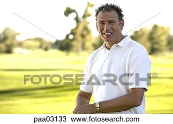 Stock Photo - man standing on 
golf course. fotosearch 
- search stock 
photos, pictures, 
images, and photo 
clipart
