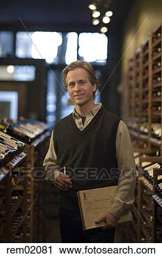 Stock Photography - man standing in 
liquor store with 
note pad. fotosearch 
- search stock 
photos, pictures, 
images, and photo 
clipart