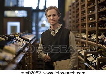 Stock Photo - man standing in 
liquor store with 
note pad. fotosearch 
- search stock 
photos, pictures, 
images, and photo 
clipart