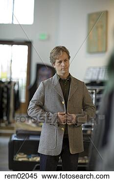 Stock Image - man trying on 
blazer in clothing 
store. fotosearch 
- search stock 
photos, pictures, 
images, and photo 
clipart