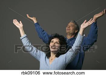 Stock Photo - man and woman 
with arms lifted 
in prayer. fotosearch 
- search stock 
photos, pictures, 
images, and photo 
clipart