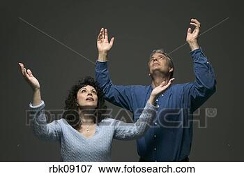 Picture - man and woman 
with arms lifted 
in prayer. fotosearch 
- search stock 
photos, pictures, 
images, and photo 
clipart