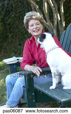 Picture - middle-aged woman 
playing with dog. 
fotosearch - search 
stock photos, 
pictures, images, 
and photo clipart