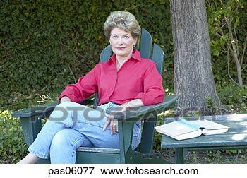 Picture - middle-aged woman 
relaxing in backyard. 
fotosearch - search 
stock photos, 
pictures, images, 
and photo clipart