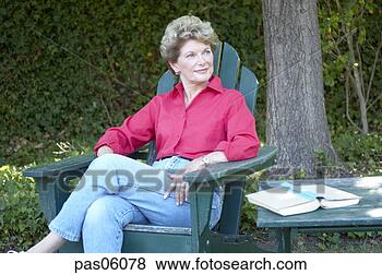 Stock Photo - middle-aged woman 
relaxing in backyard. 
fotosearch - search 
stock photos, 
pictures, images, 
and photo clipart