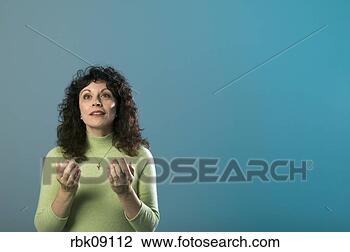 Stock Photo - middle aged woman 
lifting arms in 
prayer. fotosearch 
- search stock 
photos, pictures, 
images, and photo 
clipart