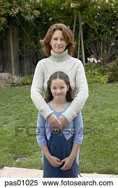 Stock Image - mother and daughter 
standing in backyard. 
fotosearch - search 
stock photos, 
pictures, images, 
and photo clipart