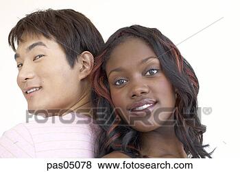 Stock Photo - multi-ethnic couple 
standing back 
to back. fotosearch 
- search stock 
photos, pictures, 
images, and photo 
clipart
