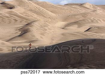 Picture - person running 
on sand dunes. 
fotosearch - search 
stock photos, 
pictures, images, 
and photo clipart
