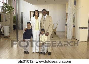 Stock Photo - portrait of family 
standing in livingroom. 
fotosearch - search 
stock photos, 
pictures, images, 
and photo clipart