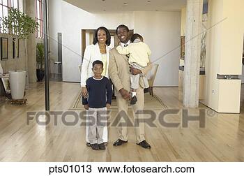Stock Photo - portrait of family 
standing in livingroom. 
fotosearch - search 
stock photos, 
pictures, images, 
and photo clipart