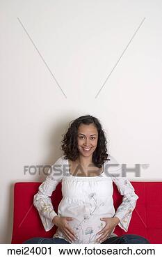 Stock Photography - pregnant woman 
rubbing stomach. 
fotosearch - search 
stock photos, 
pictures, images, 
and photo clipart