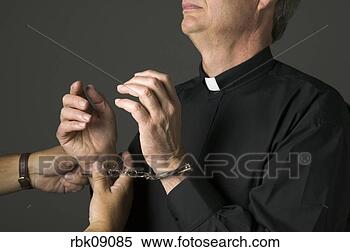 Stock Image - priest being handcuffed. 
fotosearch - search 
stock photos, 
pictures, images, 
and photo clipart
