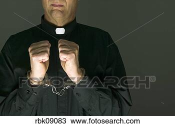 Stock Photo - priest in handcuffs. 
fotosearch - search 
stock photos, 
pictures, images, 
and photo clipart