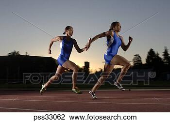 Stock Photo - relay racers passing 
baton. fotosearch 
- search stock 
photos, pictures, 
images, and photo 
clipart