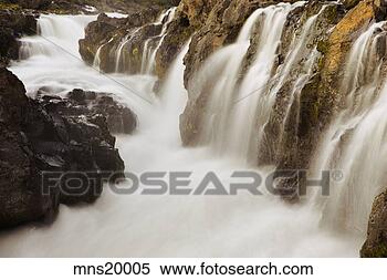 Stock Image - river rushing 
over rock formations. 
fotosearch - search 
stock photos, 
pictures, images, 
and photo clipart
