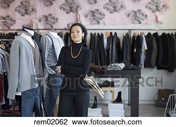 Stock Photo - sales clerk standing 
in clothing store. 
fotosearch - search 
stock photos, 
pictures, images, 
and photo clipart