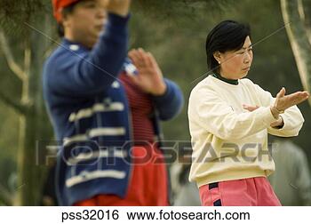 Stock Photo - senior asian adult 
practicing tai 
chi outdoors. 
fotosearch - search 
stock photos, 
pictures, images, 
and photo clipart