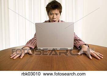Stock Photography - shocked asian 
man using laptop. 
fotosearch - search 
stock photos, 
pictures, images, 
and photo clipart