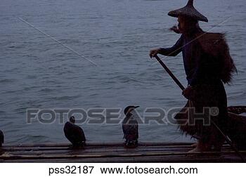 Picture - silhouette of 
person wearing 
conical hat on 
wooden raft at 
night. fotosearch 
- search stock 
photos, pictures, 
images, and photo 
clipart