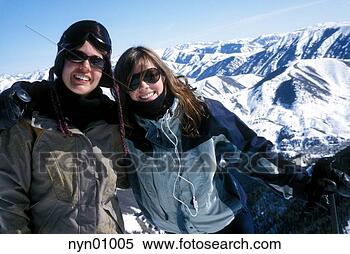 Stock Image - skiing couple 
hugging on the 
slopes. fotosearch 
- search stock 
photos, pictures, 
images, and photo 
clipart