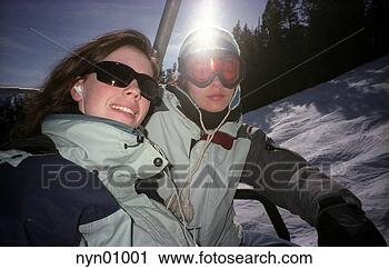 Stock Photography - skiing couple 
in ski lift. fotosearch 
- search stock 
photos, pictures, 
images, and photo 
clipart