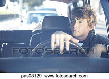 Stock Photograph - teenage boy driving 
car. fotosearch 
- search stock 
photos, pictures, 
images, and photo 
clipart