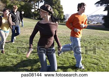 Stock Photo - teenage friends 
running in park. 
fotosearch - search 
stock photos, 
pictures, images, 
and photo clipart