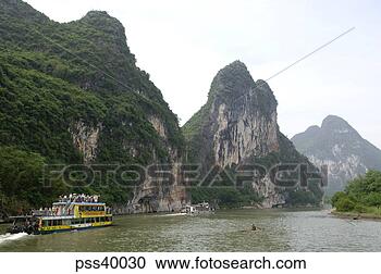 Stock Photography - tour boat sailing 
on li river, guilin, 
china. fotosearch 
- search stock 
photos, pictures, 
images, and photo 
clipart
