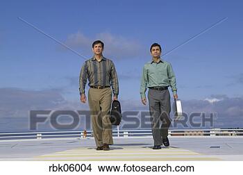 Stock Photo - two business men 
walking on roof. 
fotosearch - search 
stock photos, 
pictures, images, 
and photo clipart