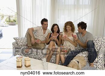 Stock Photo - two couples relaxing 
on sofa playing 
cards. fotosearch 
- search stock 
photos, pictures, 
images, and photo 
clipart