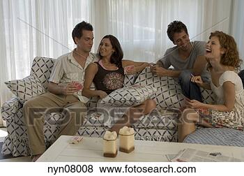 Stock Photo - two couples using 
playing cards 
on sofa. fotosearch 
- search stock 
photos, pictures, 
images, and photo 
clipart