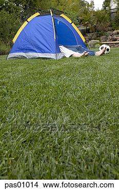 Stock Photo - two pairs of feet 
sticking out from 
tent in backyard. 
fotosearch - search 
stock photos, 
pictures, images, 
and photo clipart