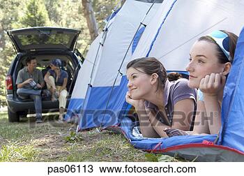 Stock Photo - two sisters daydreaming 
in tent. fotosearch 
- search stock 
photos, pictures, 
images, and photo 
clipart