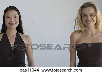 Stock Photo - two women standing 
together. fotosearch 
- search stock 
photos, pictures, 
images, and photo 
clipart