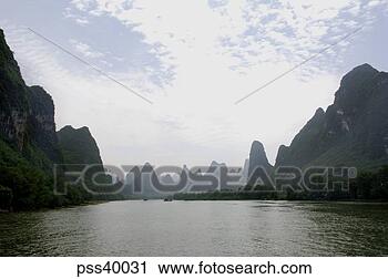 Stock Photography - view of raft on 
li river with 
guilin karst limestone 
mountains. fotosearch 
- search stock 
photos, pictures, 
images, and photo 
clipart