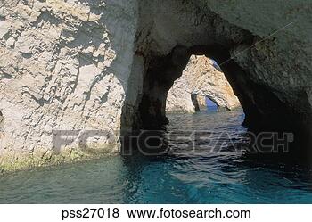 Stock Photo - view of rock wall 
and natural rock 
archways by sea. 
fotosearch - search 
stock photos, 
pictures, images, 
and photo clipart