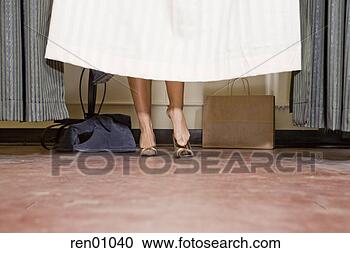 Stock Photography - woman behind fitting 
room curtain. 
fotosearch - search 
stock photos, 
pictures, images, 
and photo clipart