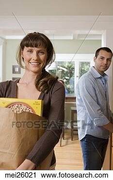 Stock Photography - woman carrying 
grocery bag. fotosearch 
- search stock 
photos, pictures, 
images, and photo 
clipart
