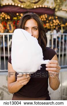 Stock Photo - woman eating cotton 
candy. fotosearch 
- search stock 
photos, pictures, 
images, and photo 
clipart