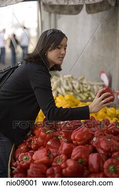Stock Photography - woman examining 
bell peppers. 
fotosearch - search 
stock photos, 
pictures, images, 
and photo clipart