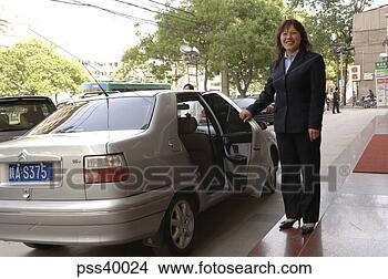 Stock Photo - woman holding 
car door open, 
xi'an, china. 
fotosearch - search 
stock photos, 
pictures, images, 
and photo clipart